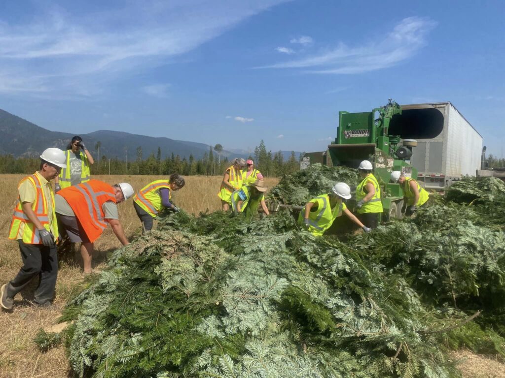 05. CARE Instructors loading Grand Fir branches into the chipper