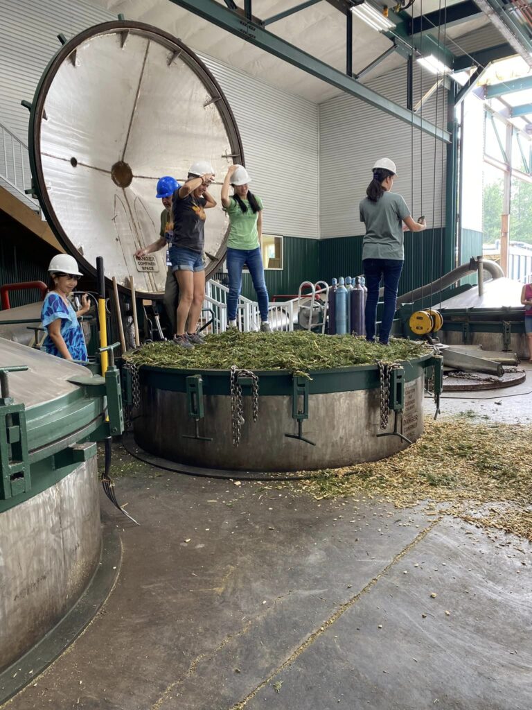 15. CARE Instructors packing down Grand Fir material into the distiller